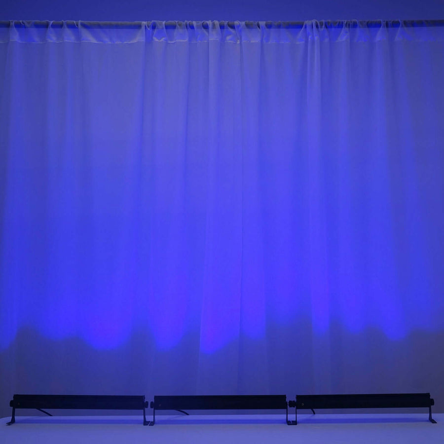 Background with blue lighting and draped curtains, creating a serene atmosphere.