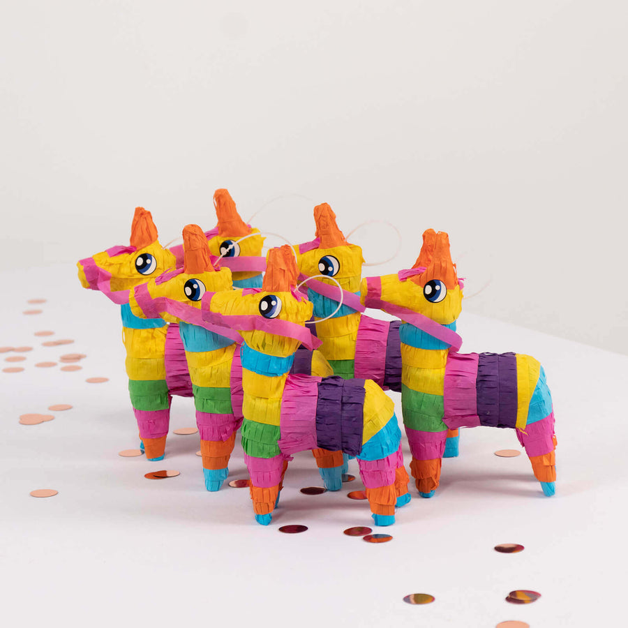 Colorful miniature piñatas in a playful arrangement.