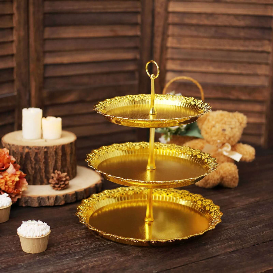 Gold three-tiered serving stand with decorative edges on a rustic wooden table.