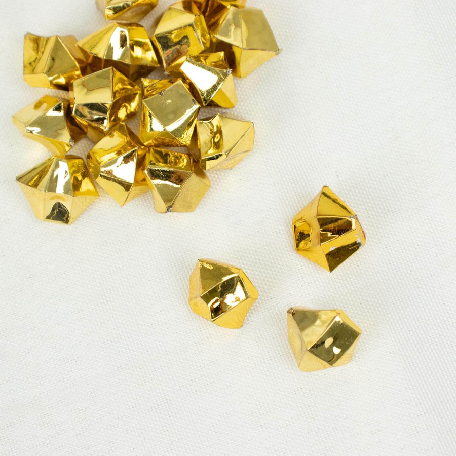 Shiny gold geometric decorative pieces on a light background.