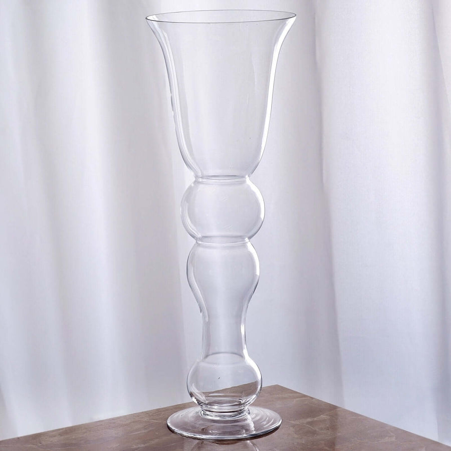 Clear glass vase with a unique bubbled design, elegantly shaped for decor.