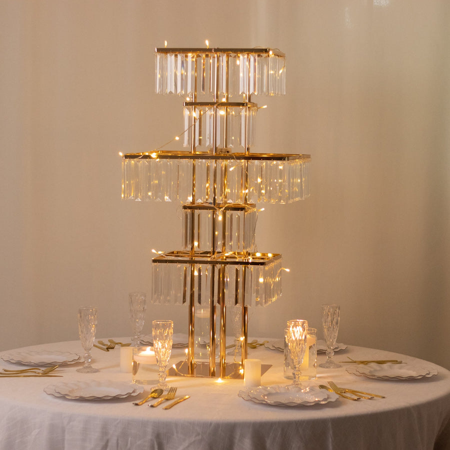 Elegant gold and glass table lamp with fairy lights on a dining table setting.