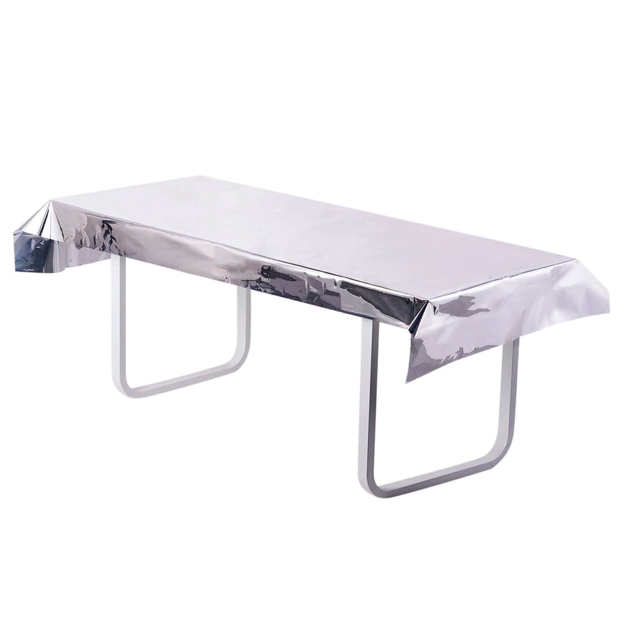 Silver table cover on a white table, styled for protection and decoration.