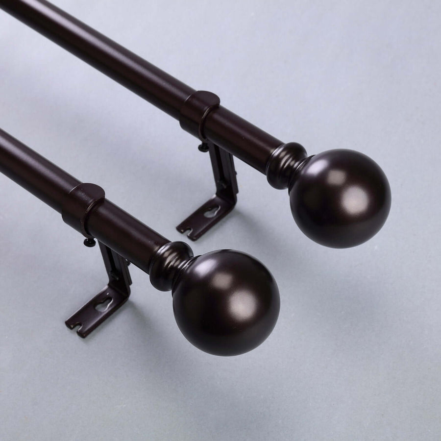 Bronze curtain rods with decorative finials, showcasing elegant design.