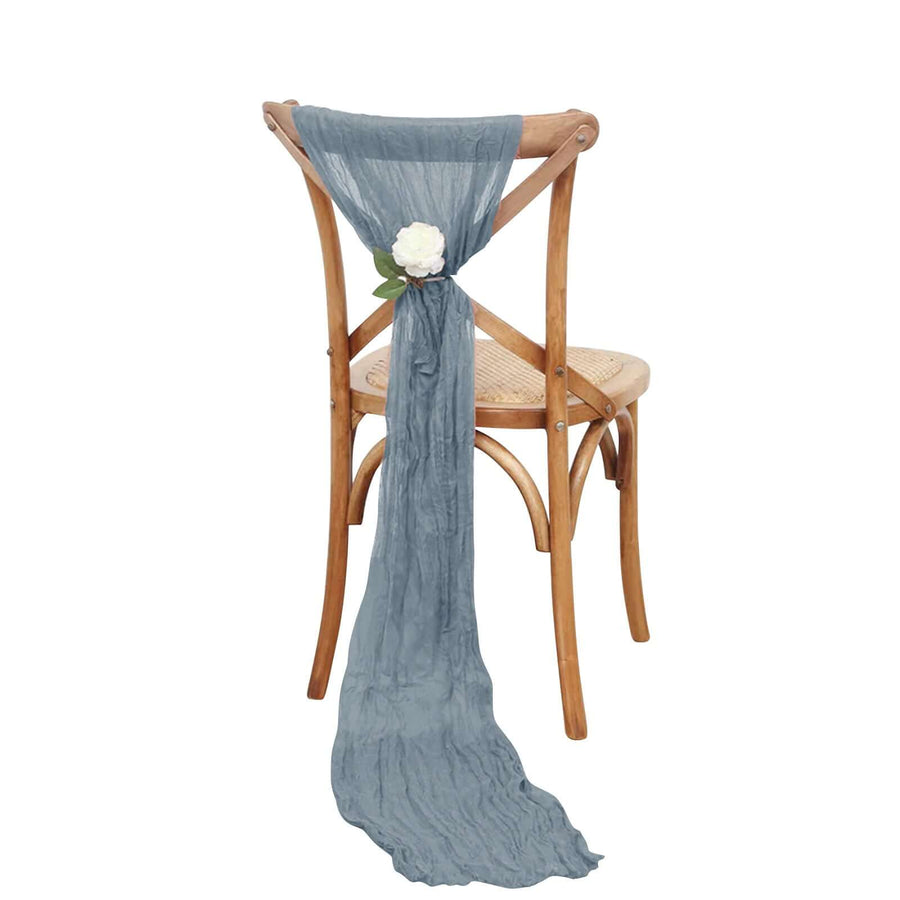 Decorative blue scarf tied on a wooden chair with a white flower accent.