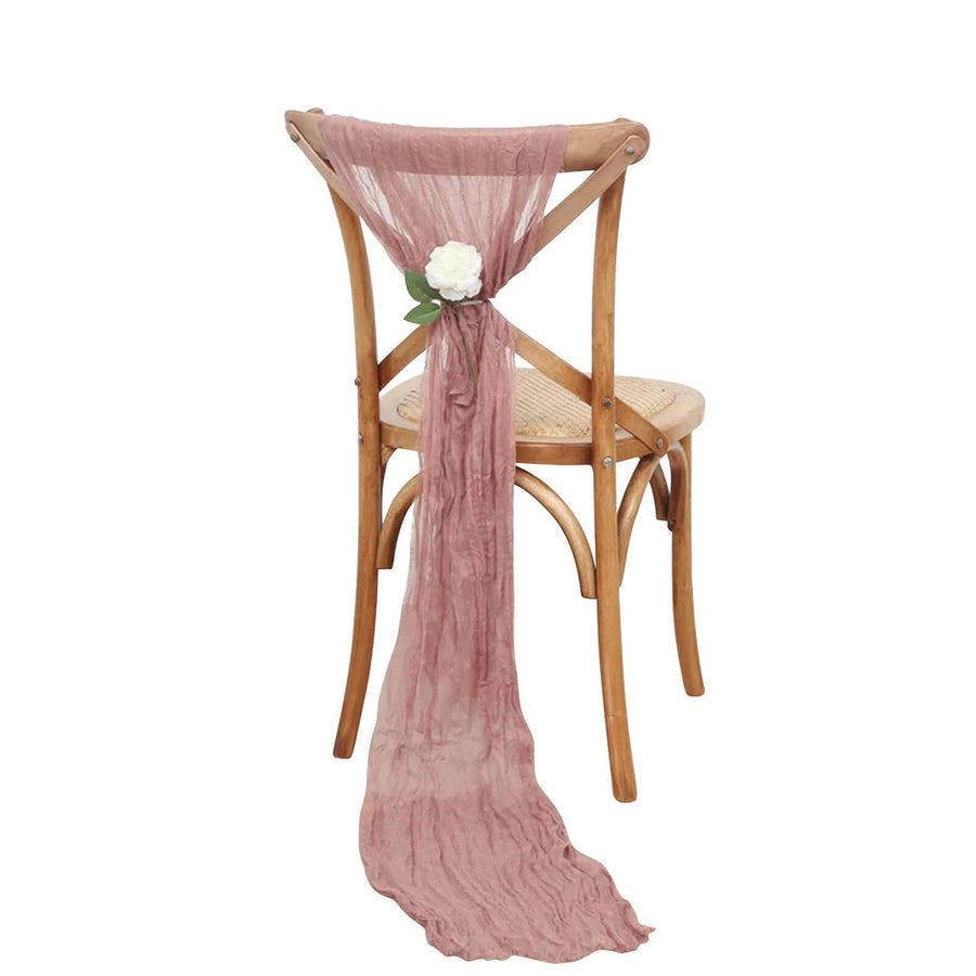 Rustic chair with draped mauve fabric and floral accent