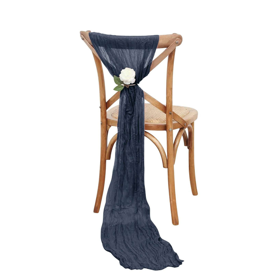 Navy blue chair sash with flower detail draped on a wooden chair