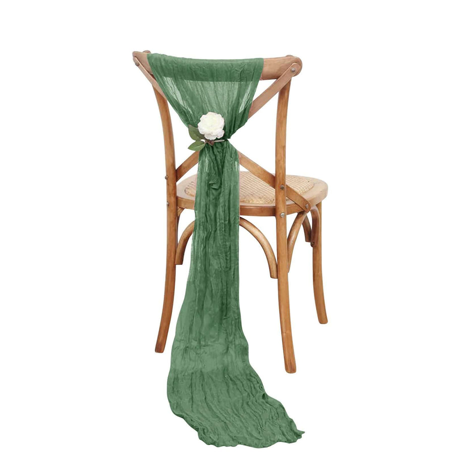 Green chiffon chair sash with flower accent on wooden chair