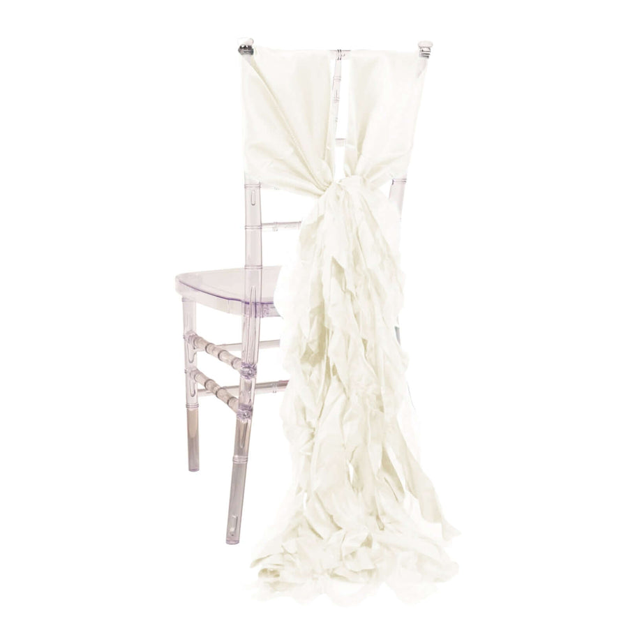 White fabric chair sash tied in a bow on a clear chiavari chair.