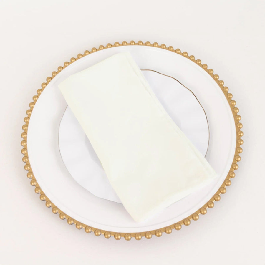 Elegant white napkin on a decorative plate.