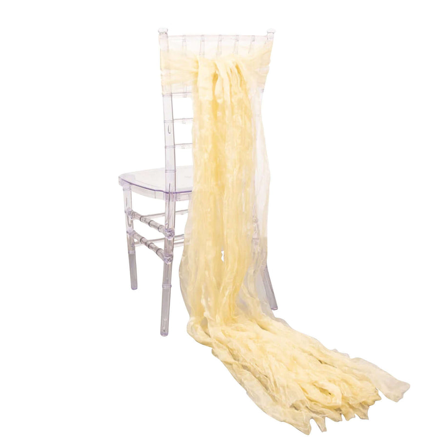 Yellow chiffon drape cascading from a clear acrylic chair