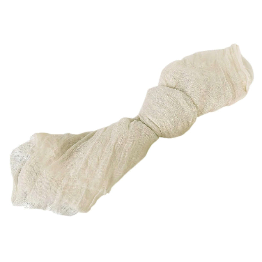 Light beige textured scarf tied in a bow.