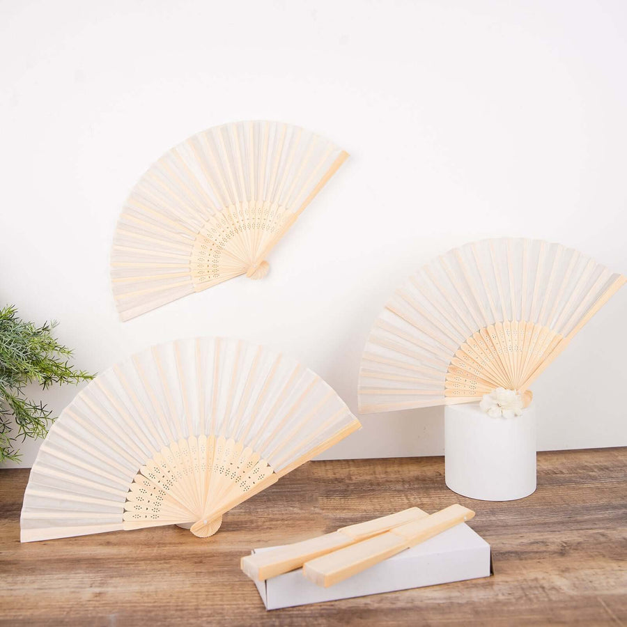 Decorative paper fans in various sizes on a wooden surface.