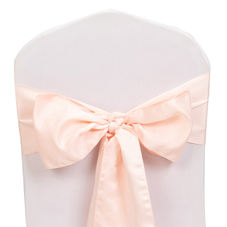 Peach satin chair sash with a bow on a white background