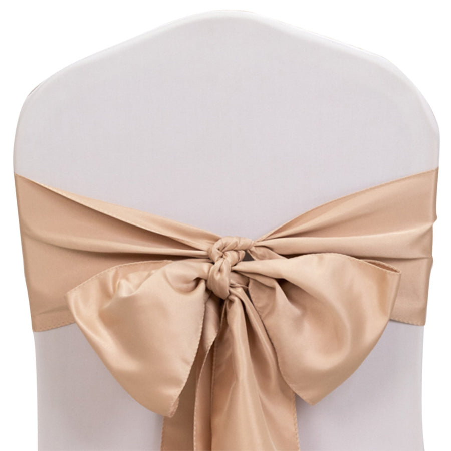 Satin chair sash in champagne color tied in a bow on a white chair