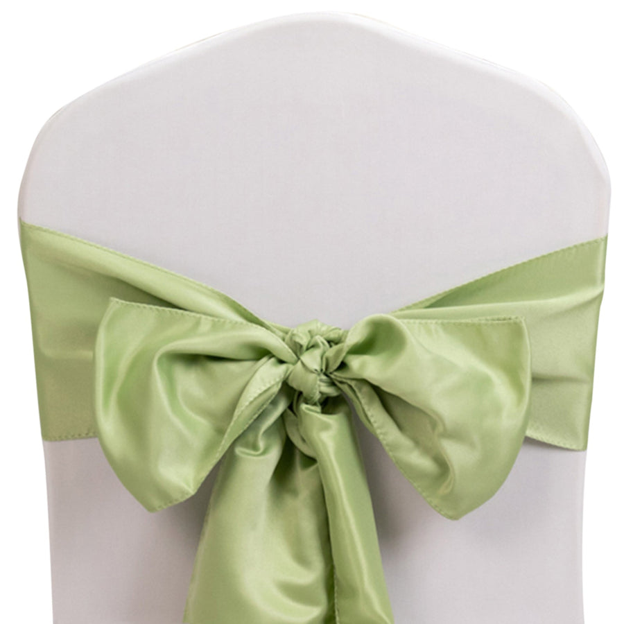 Green satin chair sash tied in a bow on a white chair.