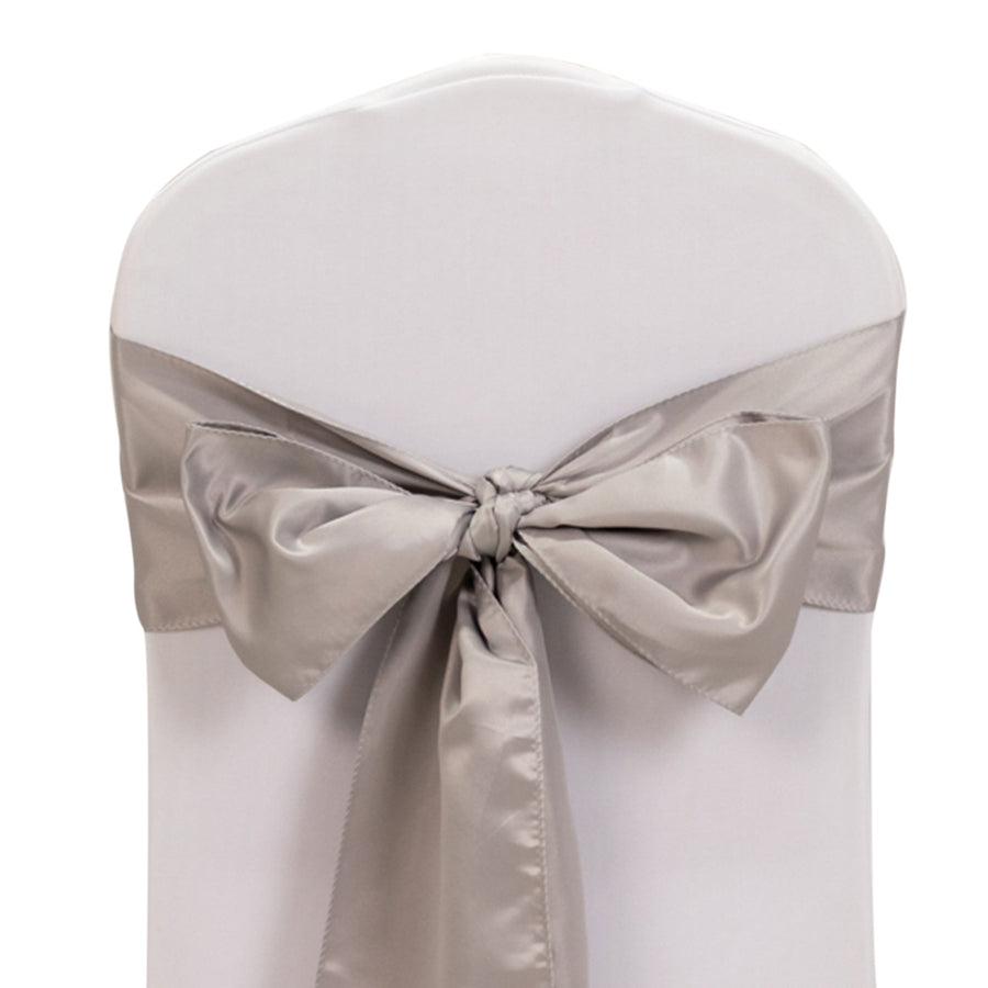 Elegant chair cover with silver satin bow on a white backdrop.
