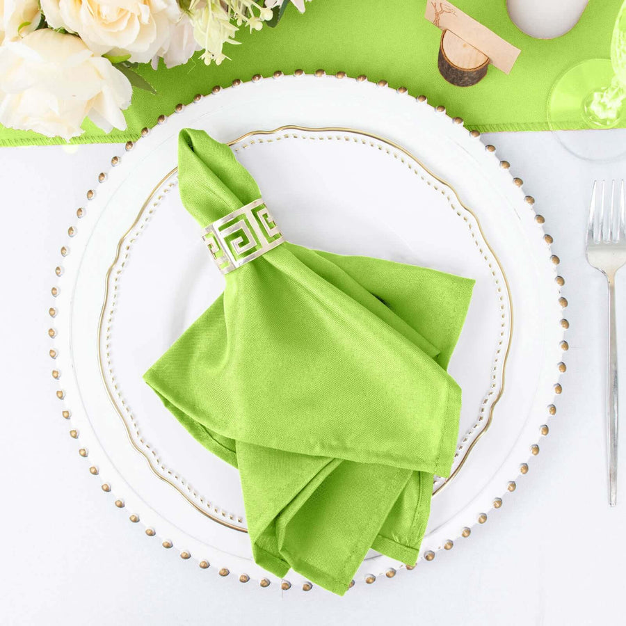 Green napkin elegantly arranged on a decorative plate with a gold rim.