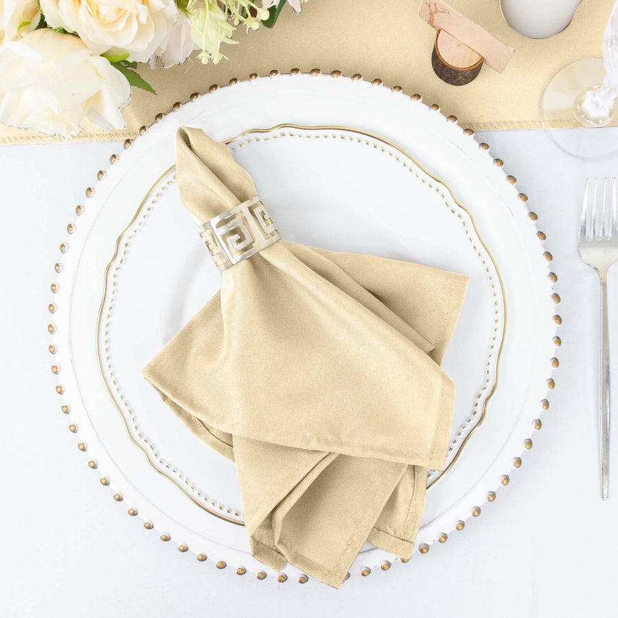 Elegant beige napkin elegantly folded on a decorative plate with a ring.