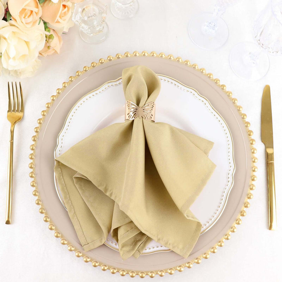 Elegant gold napkin with a bow on a decorative plate set for a dining experience.
