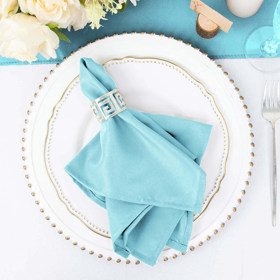 Turquoise napkin with decorative ring on elegant plate setting