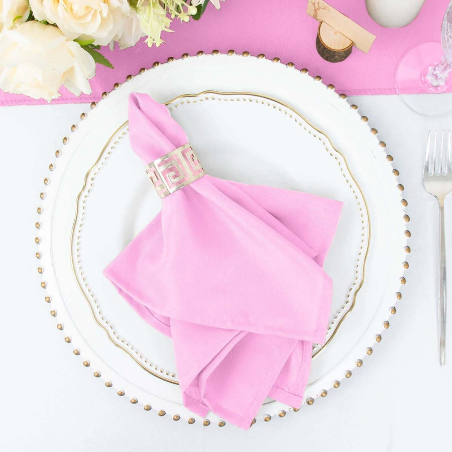 Pink napkin elegantly styled on a decorative plate with floral accents.