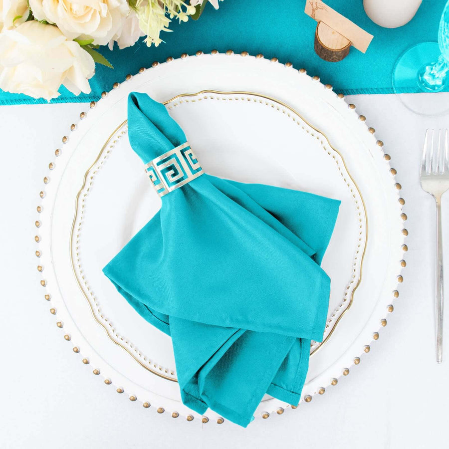 Turquoise napkin with decorative ring on elegant plate setting