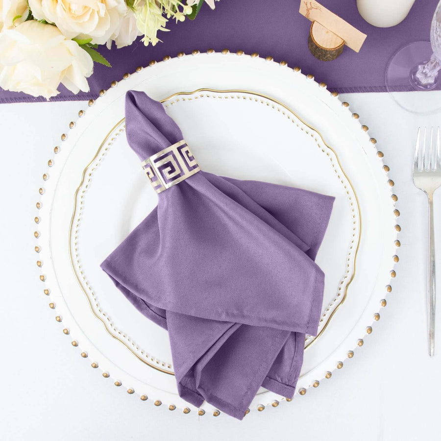 Purple napkin on an elegant plate with a decorative gold ring.