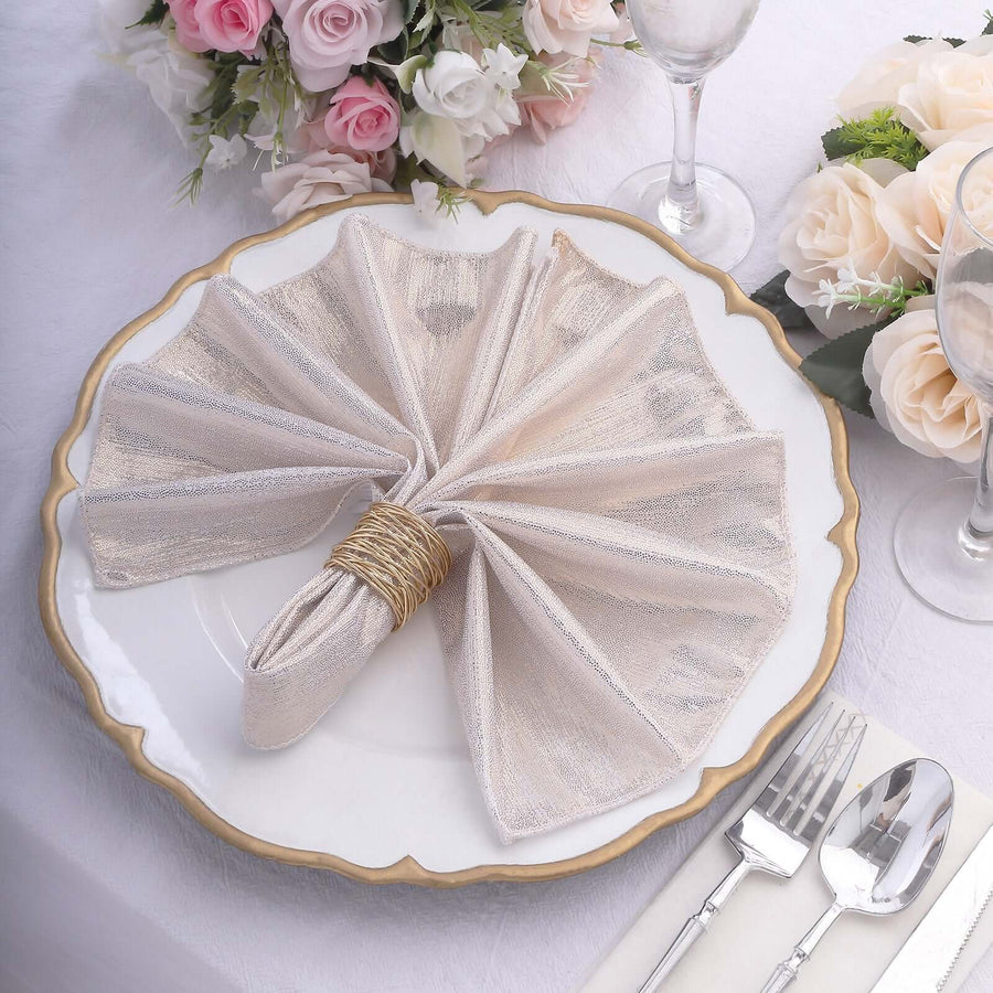 Elegant folded napkin on a decorative plate set for dining.