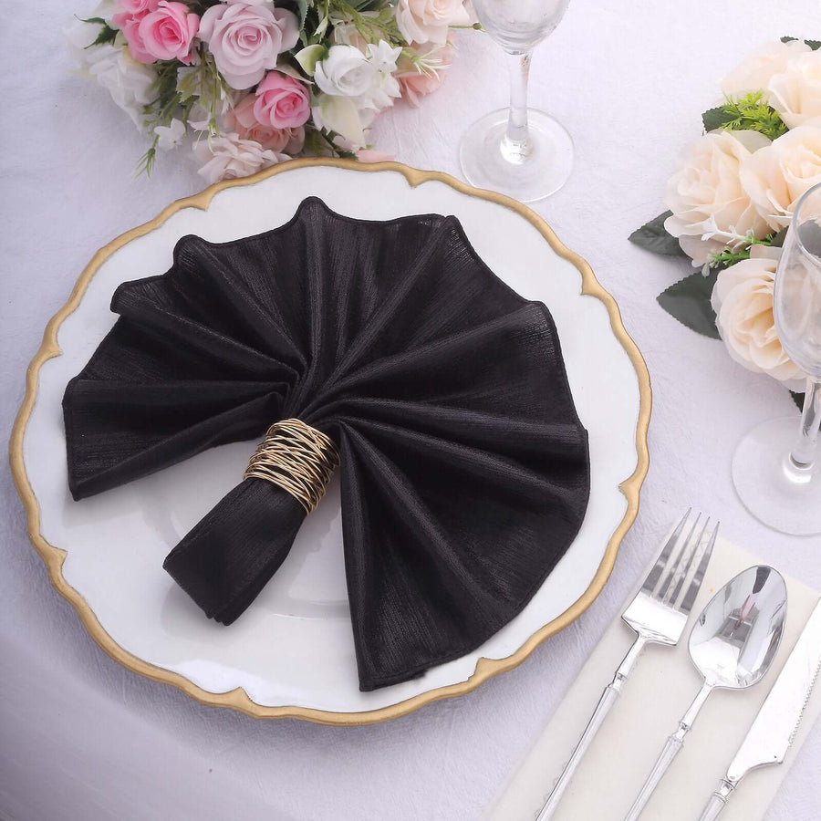 Elegant black napkin elegantly folded on a decorative plate with floral accents.