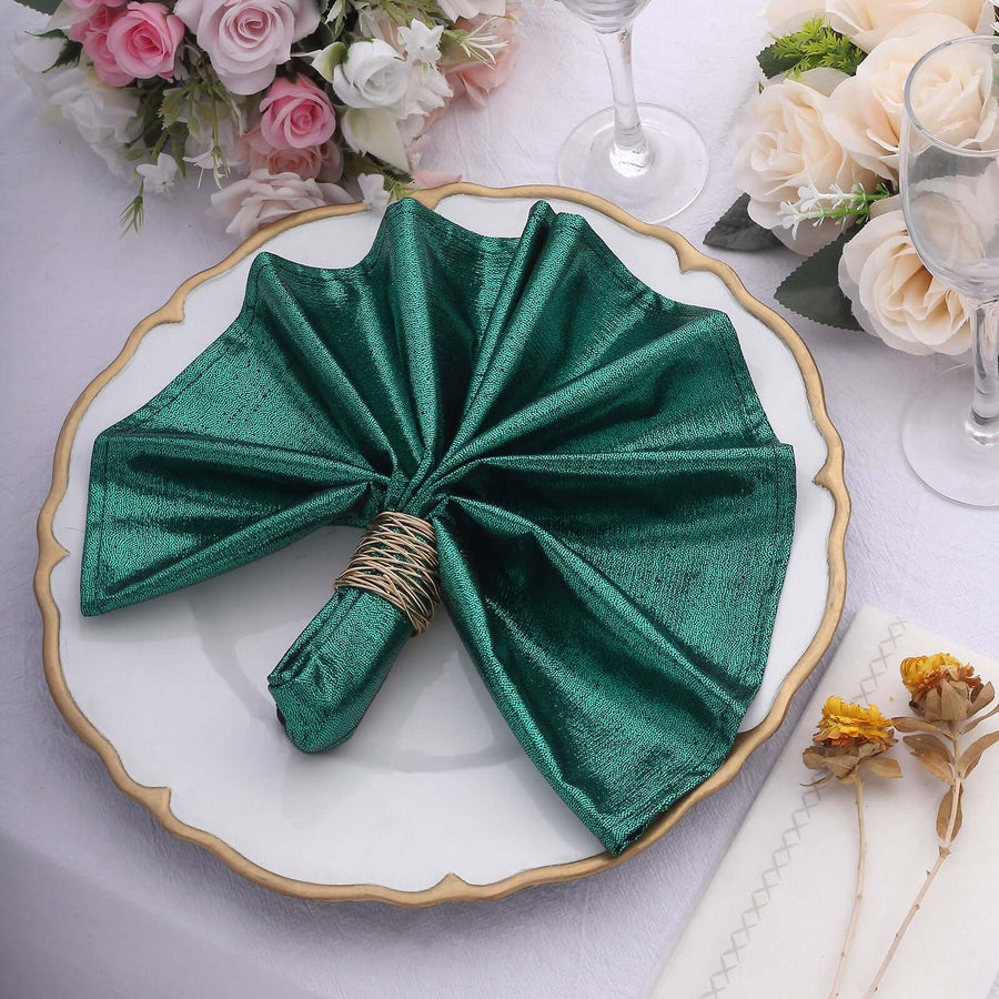 Elegant green napkin folded beautifully on a decorative plate.