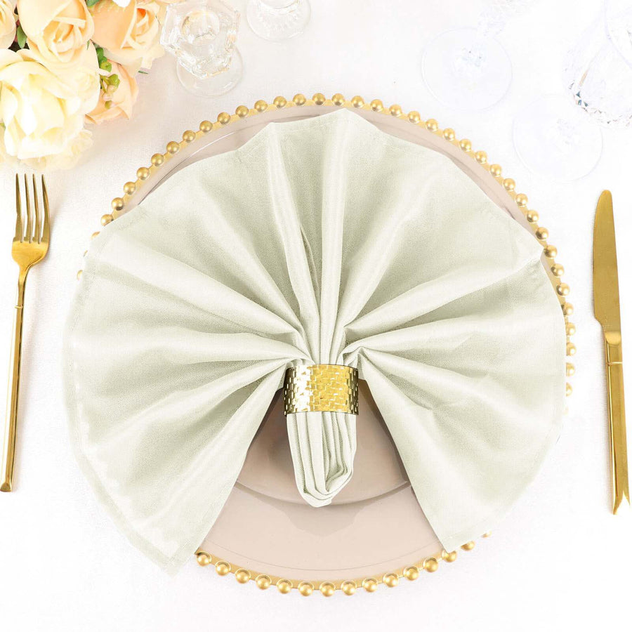 Elegant green napkin arranged on a decorative plate with gold accents.