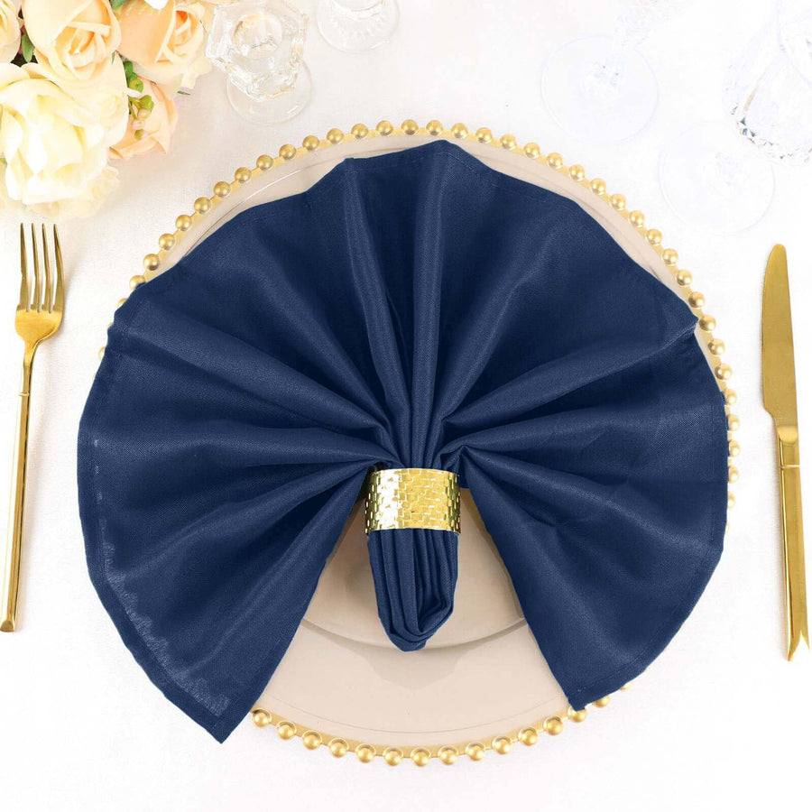 Navy napkin elegantly displayed on a decorative plate with gold accents.