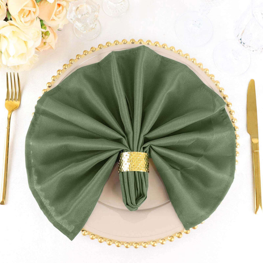 Elegant green napkin arranged on a decorative plate with gold accents.