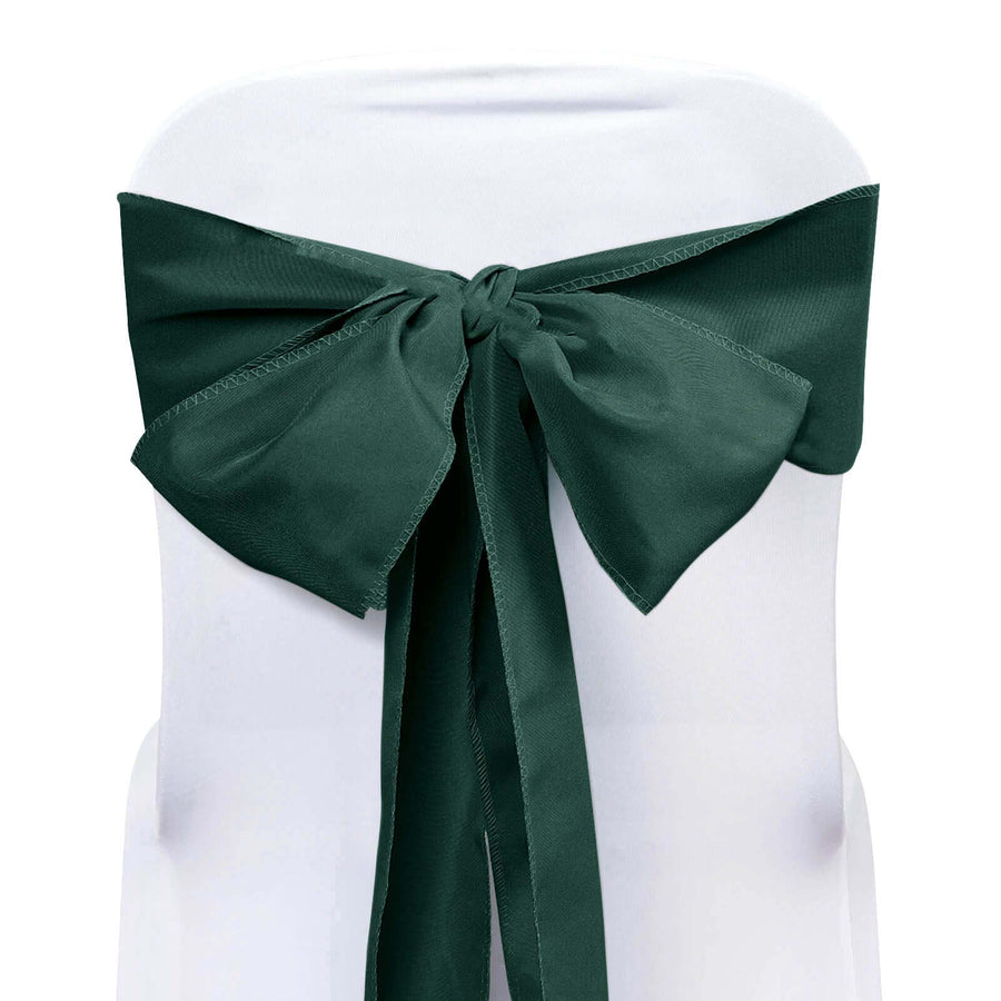 Dark green chair sash tied in a bow on a white chair. #whtbkgd