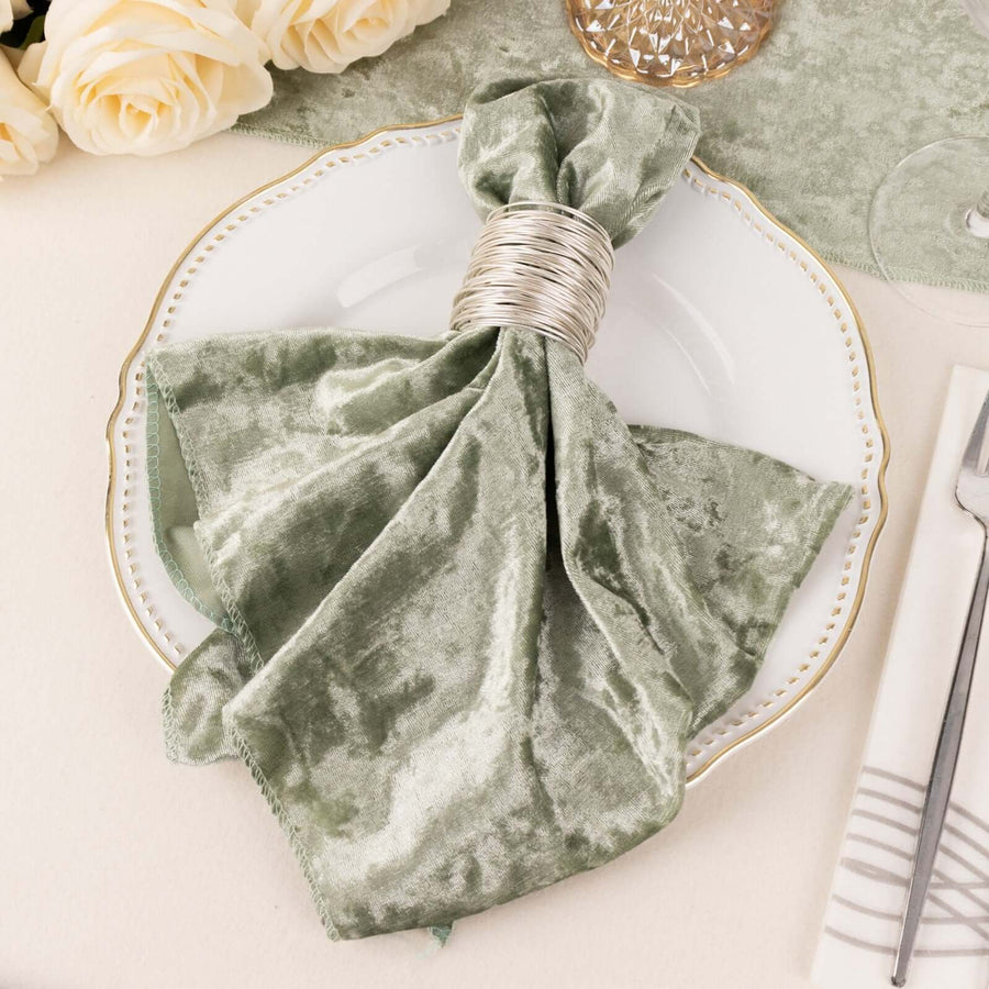 Velvet green napkin with silver napkin ring on a decorative plate