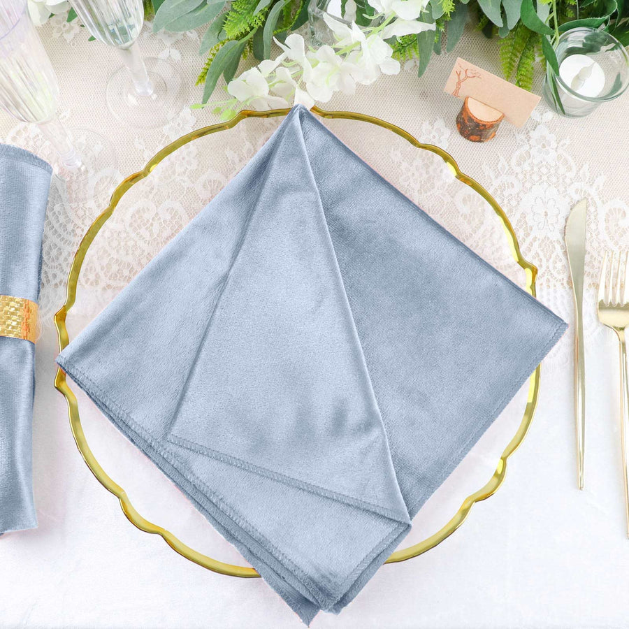 Elegant gray napkin neatly folded on a decorative gold plate.