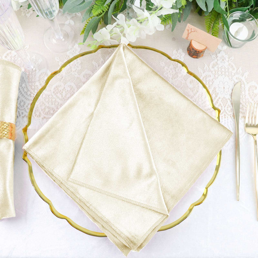 Elegant gold napkin displayed on a decorative plate at a refined table setting.