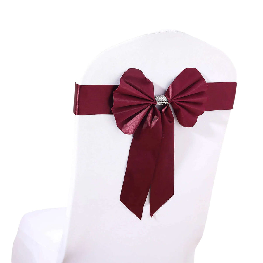 Burgundy satin chair sash with decorative bow and rhinestone accent