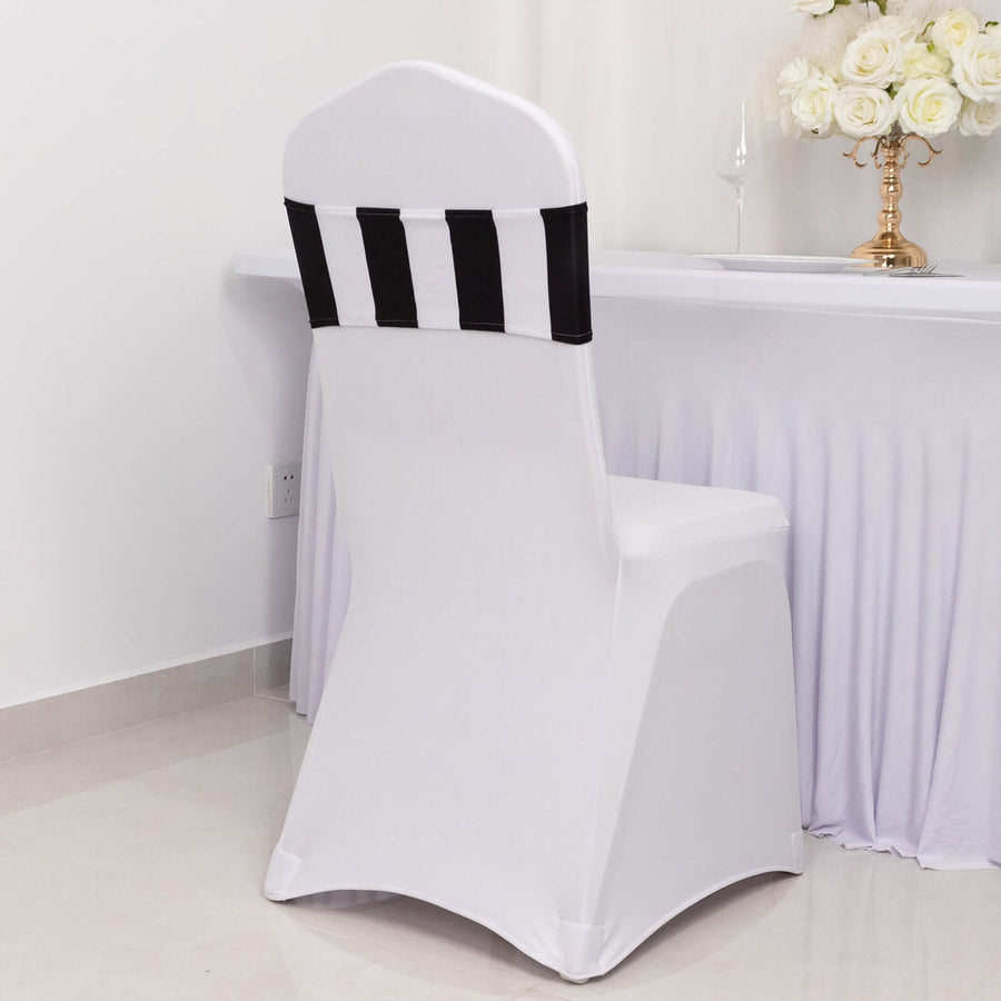 White chair cover with black stripes on a plain backdrop