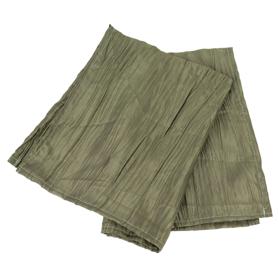 Olive green pleated fabric sheets stacked on a white background