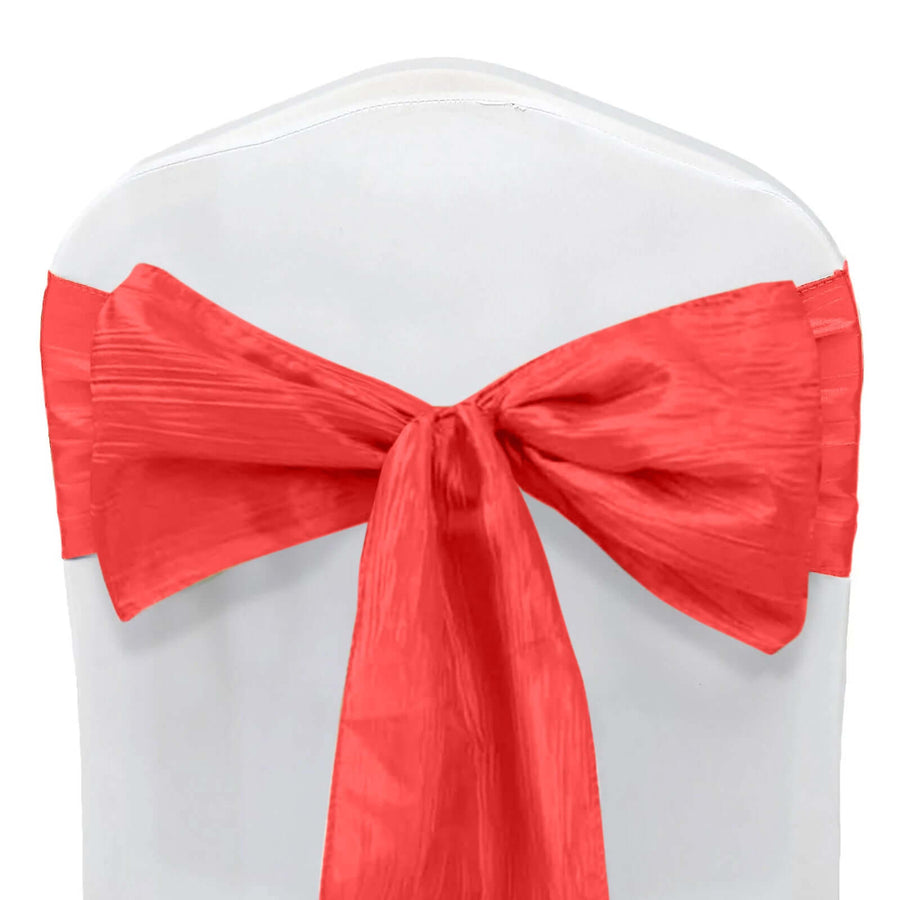 Red satin chair sash tied in a bow on a white chair. #whtbkgd