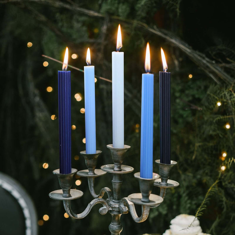 Elegant candelabra with five colorful candles glowing in a festive setting.
