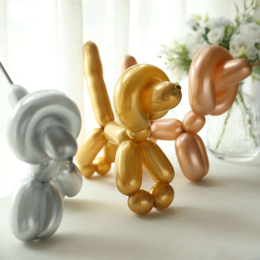 Balloon animal sculptures in metallic colors on a light background.
