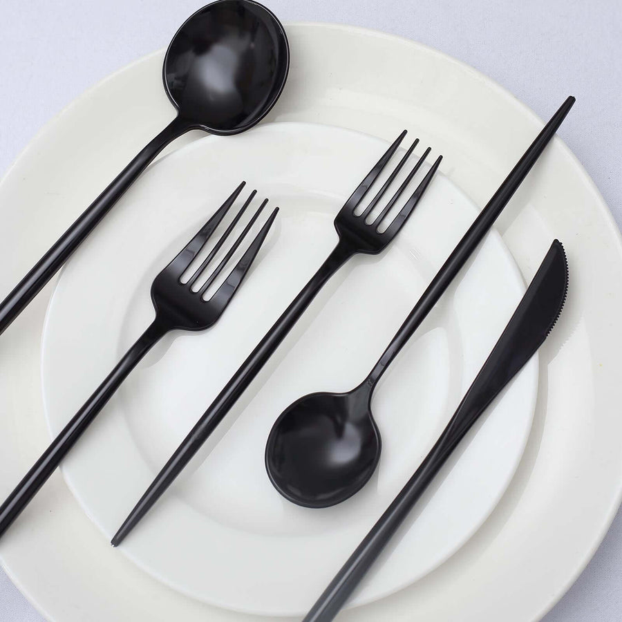 Black plastic cutlery set on white plates