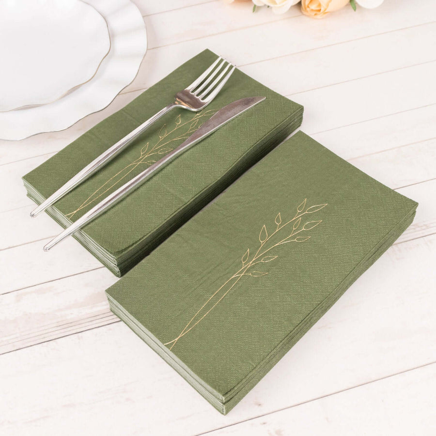 Green napkins with elegant gold leaf design, arranged with silver cutlery.