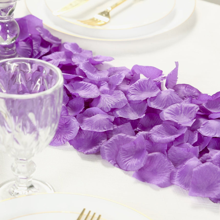 Purple silk rose petals arranged elegantly on a dining table.
