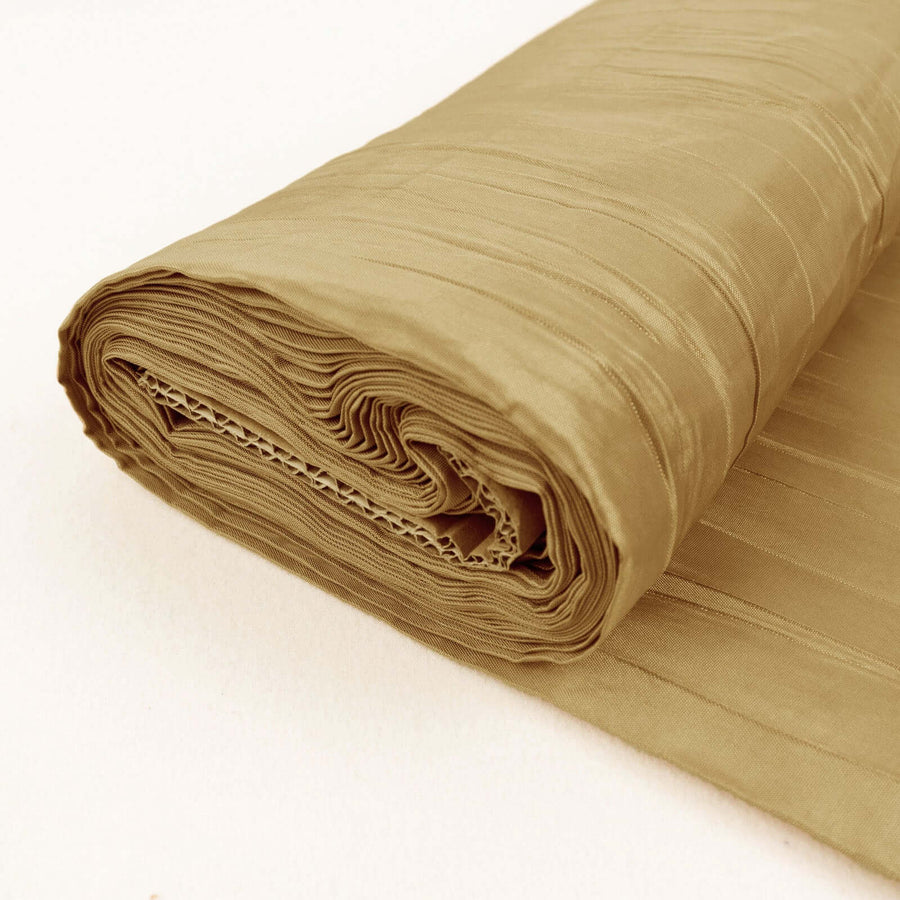 Rolled beige fabric with a textured finish on a plain background