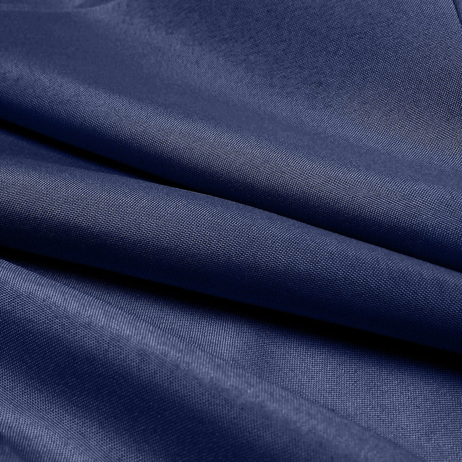 Navy blue fabric texture with smooth, folded layers.