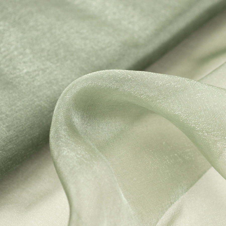 Soft green fabric draped elegantly, showcasing its delicate texture and sheen.